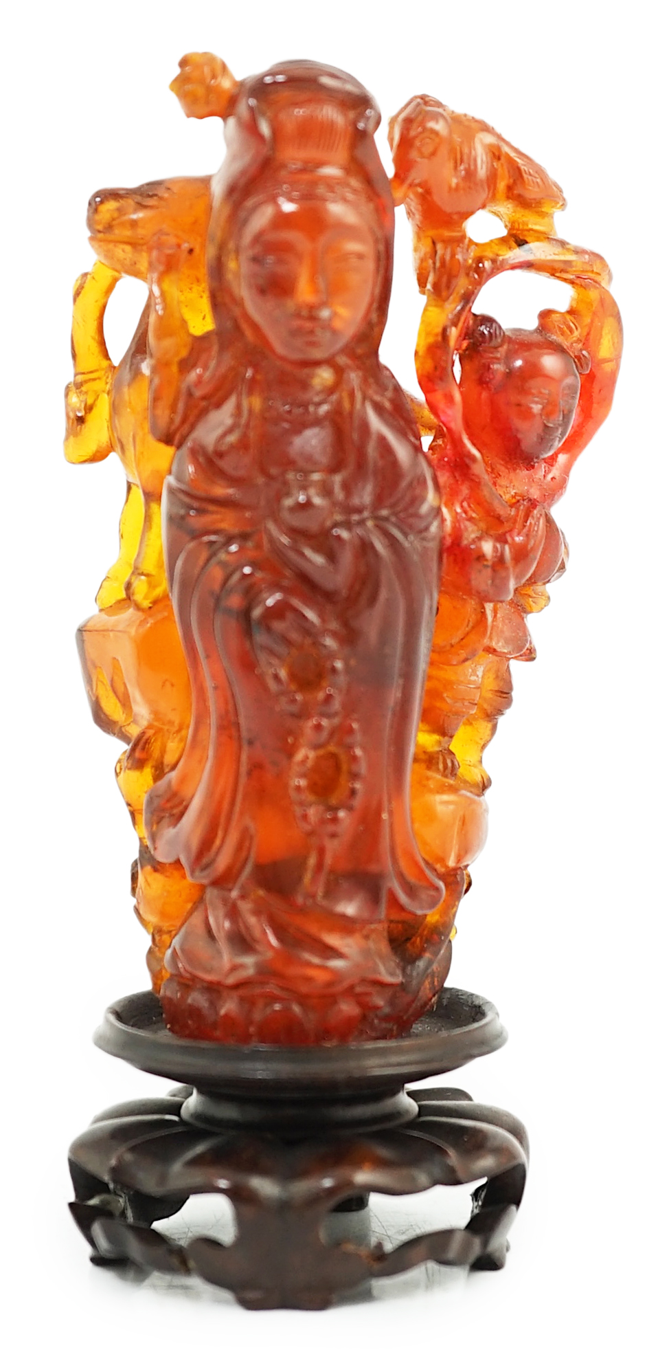 A Chinese amber group of Guanyin, 19th century, small losses
